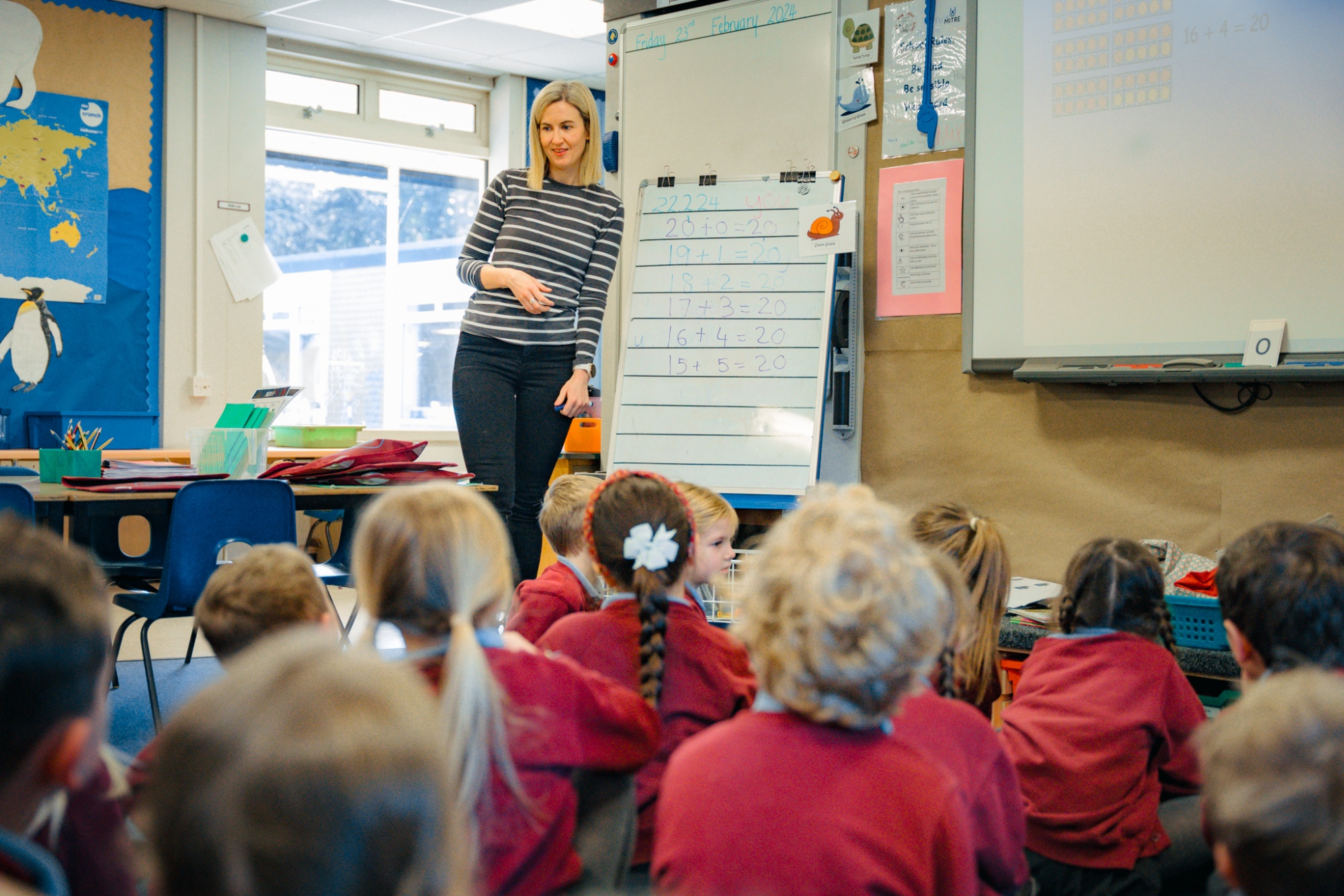 teacher talking to students in classroom