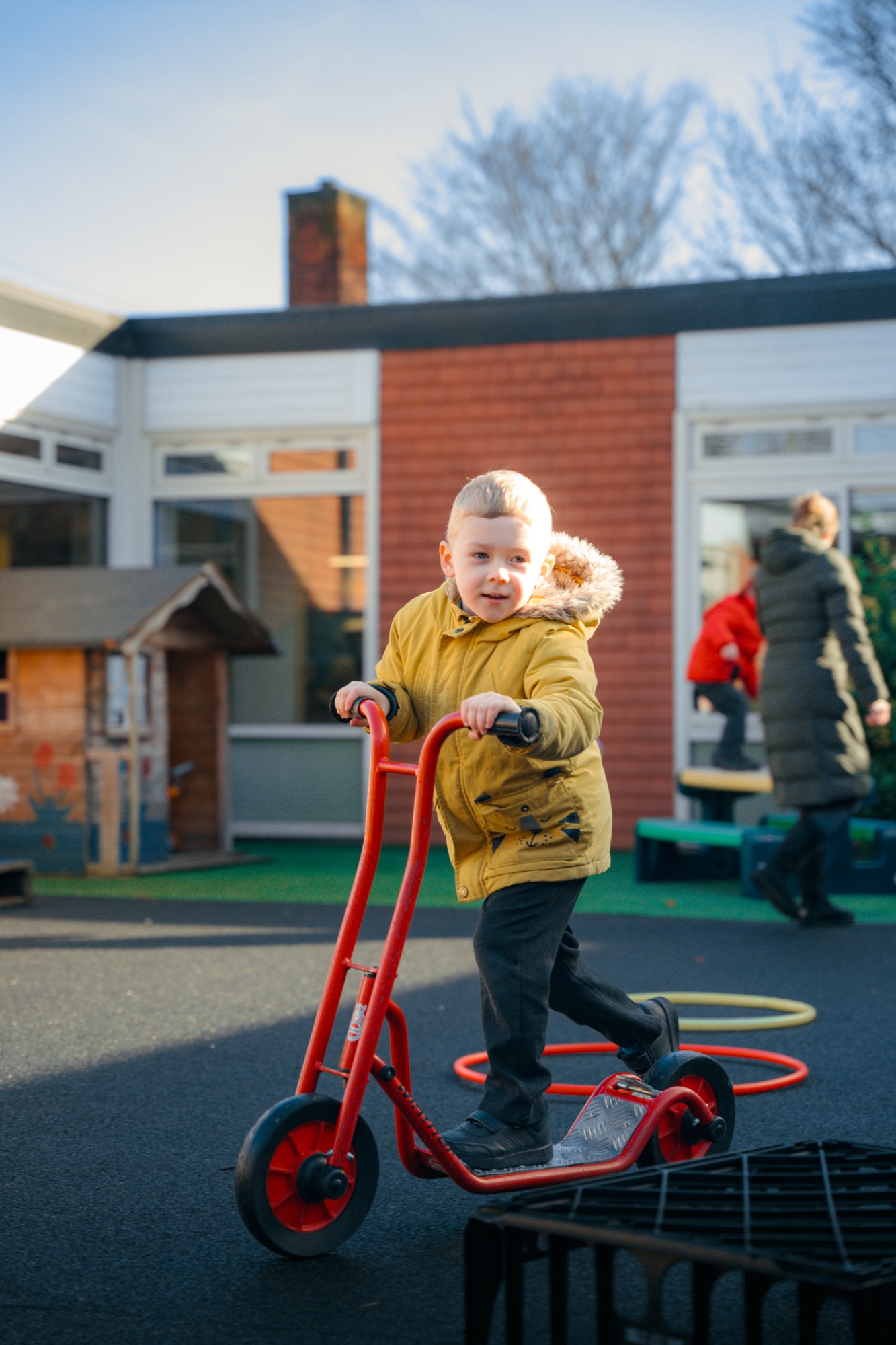 child on scooter in playground