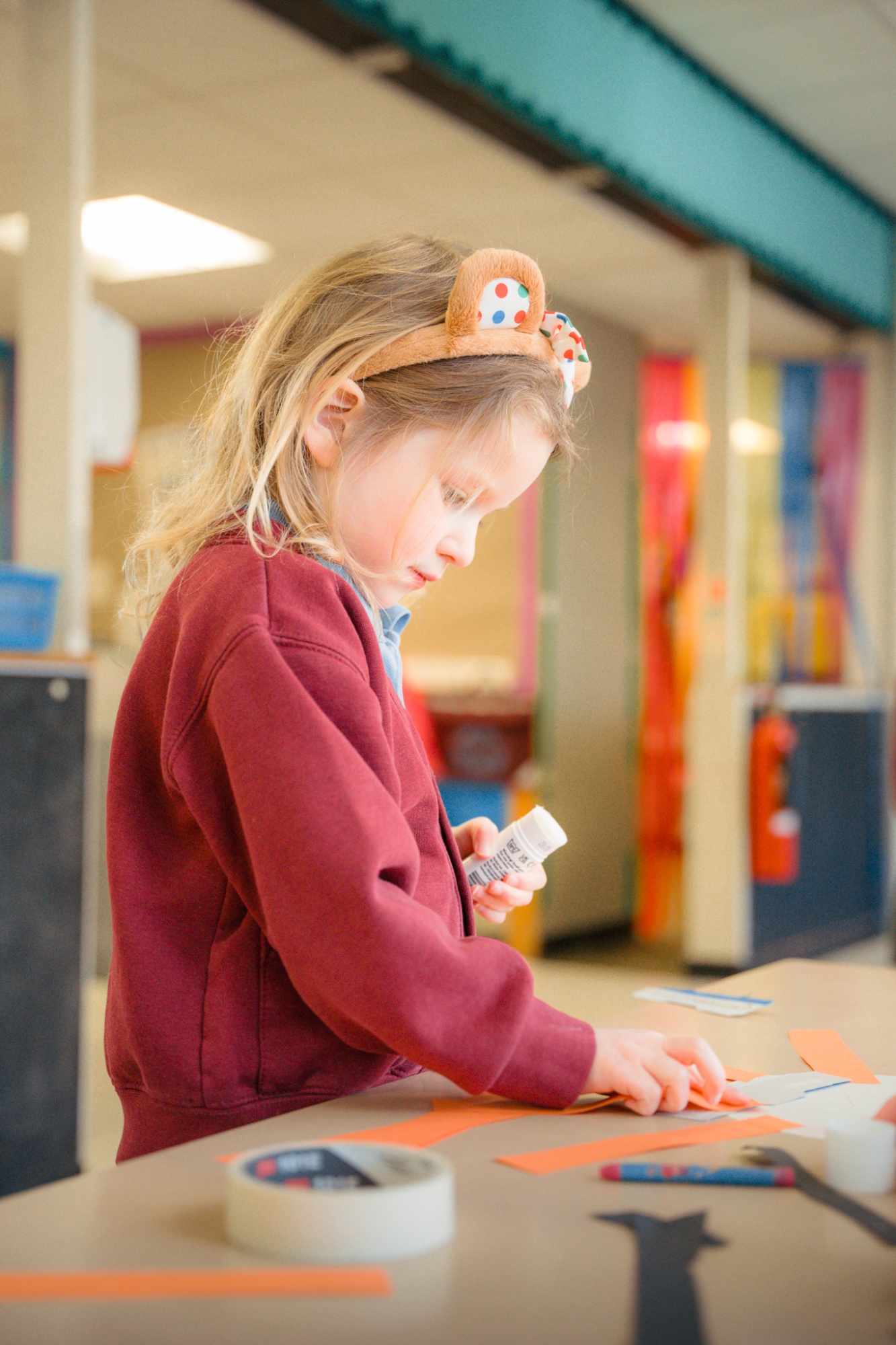 student crafting at classroom table