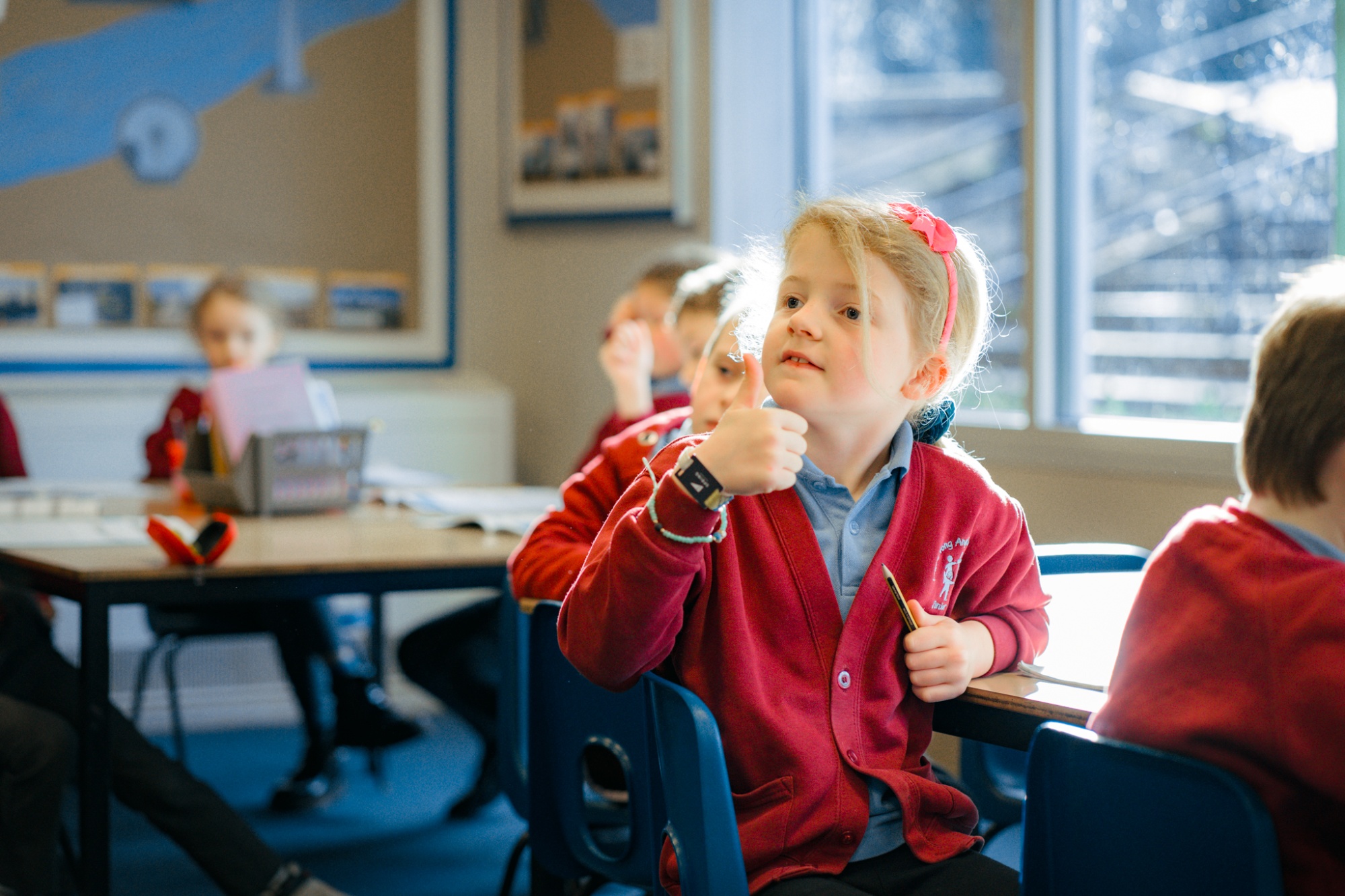 child giving thumbs up to camera