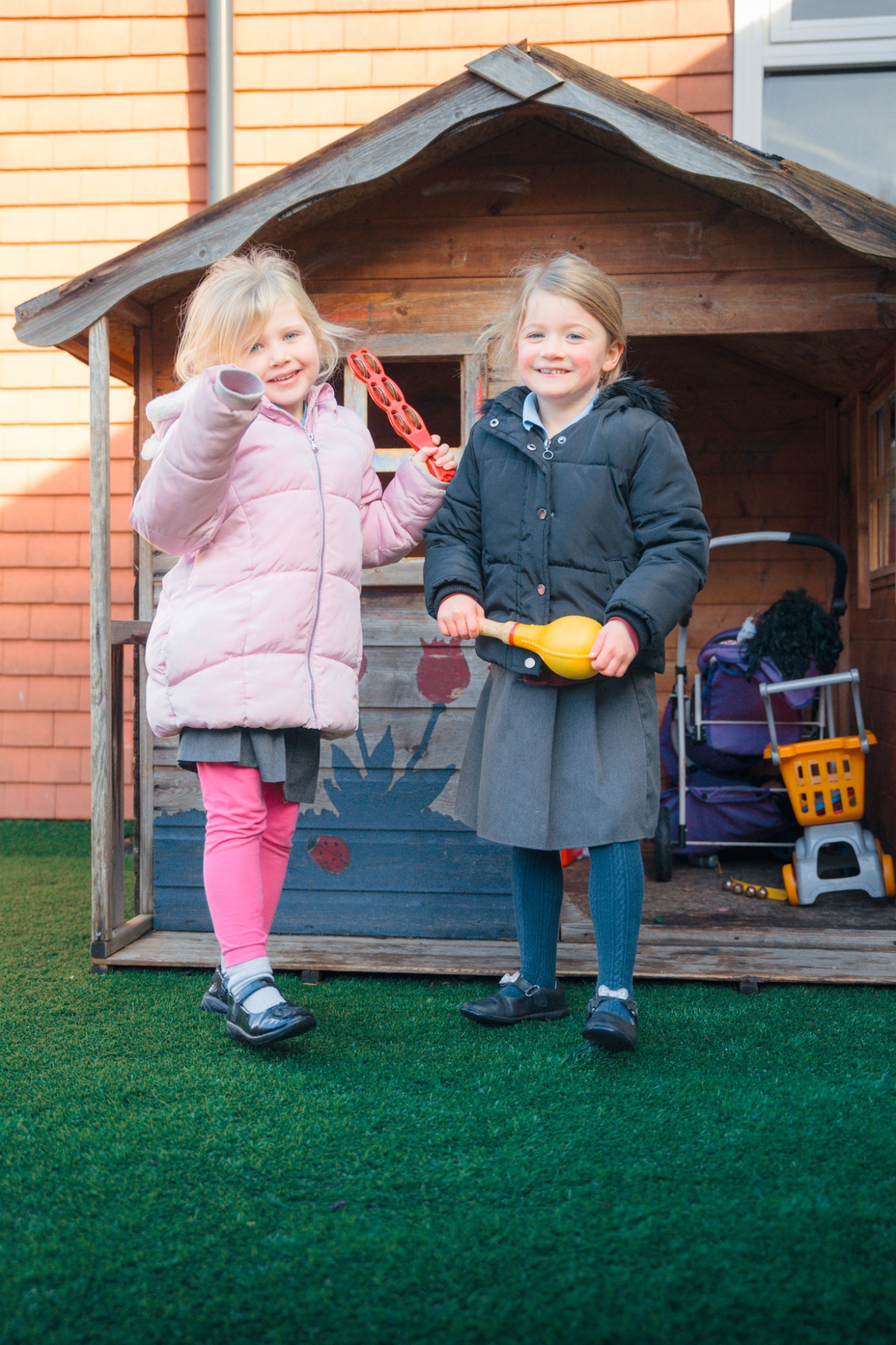 two girls playing in wendy house at break time